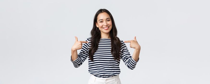 Lifestyle, beauty and fashion, people emotions concept. Smiling friendly-looking woman ready to help, pointing herself with pleasant look, bragging own accomplishments, whtie background.