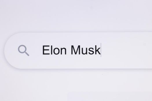 Typing Elon Mask Into Address Bar. Searching For an Online Network Website. Searching The World Wide Web Internet on a Computer. Monitor Screen View of Search for a Webpage.