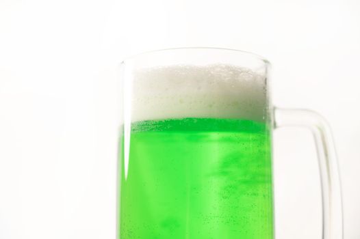 A pint of green beer for st patrick's day on a white background. Traditional Irish drink for a holiday.