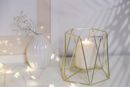 Two unopened hyacinths in a glass vase with artificial ice. Interior view in modern scandinavian style with painting canvas or poster on the wall. Living room, chest of drawers with vases.