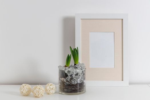 Blank canvas frame mockup. Artwork in interior design. View of modern scandinavian style interior with canvas for painting or poster on wall. Living room, commode with vases. Minimalism concept