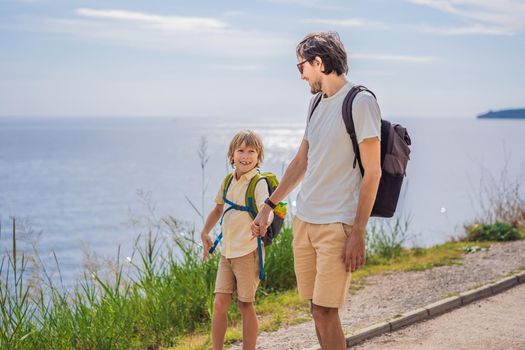 Dad and son tourists walks along the coast of Budva in Montenegro.