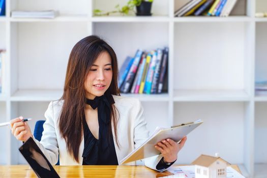 Portrait of Young economists or accountants or financiers and investors are reviewing budget documents and using computers to study impact and risk assessments on corporate investment management