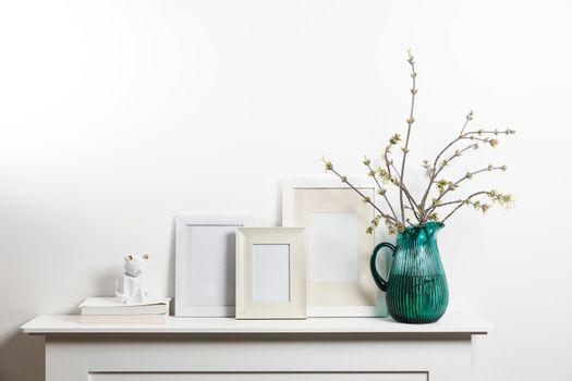 American maple branches in green glass jar and frame for photo