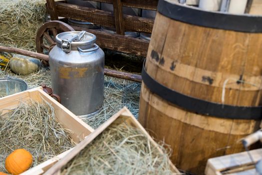 Milk - decoration on farm. Agriculture, farming. Farmer milk in bottles. Natural milk, organic milk. Vintage ornament with hay, straw and bottles with yogurt. Farmer product. Rustic decor. Products