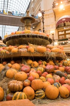 MOSCOW, RUSSIA - SEPTEMBER 25, 2021: Halloween, autumn decor of fountain on GUM department store (State Department Store) in Moscow city, Russia. Decoration with decorative pumpkins. Shop ornaments