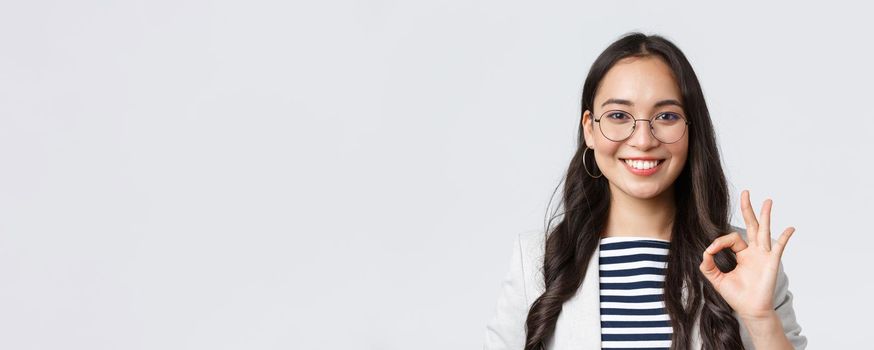 Business, finance and employment, female successful entrepreneurs concept. Close-up of professional real estate broker guarantee quality of her service, showing okay sign and smiling confident.