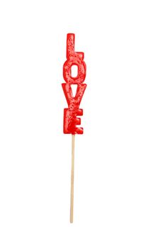 red lollipop in the form of the word Love on a stick isolated on white. Gift for Valentine's Day.