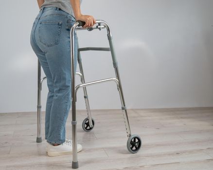 Close-up of female legs with walkers. The girl walks with the help of special equipment