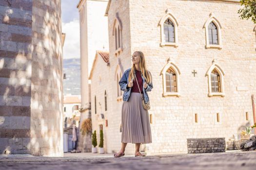 Young woman tourist in the old town of Budva. Travel to Montenegro concept.