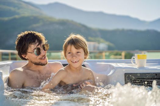 Portrait of young carefree happy smiling happy family relaxing at hot tub during enjoying happy traveling moment vacation. Life against the background of green big mountains.