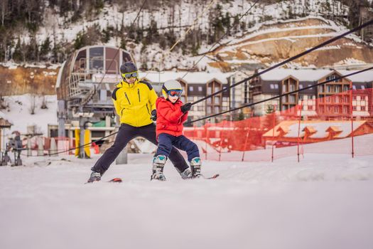 Instructor teaches boy skier to use on ski lift.