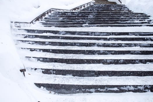 Snow-covered steps leading up to the building