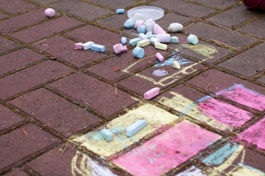 Colored chalk on playground with drawings on street