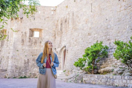 Young woman tourist in the old town of Budva. Travel to Montenegro concept.