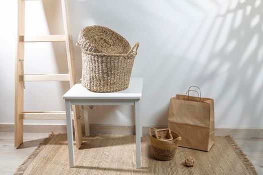 Storage room. Wooden stairs, wicker baskets on a mat. Copy space. Place for text. Copy space