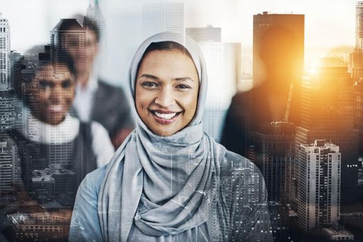 Portrait of confident young business people standing with their arms folded inside of the office at work during the day.