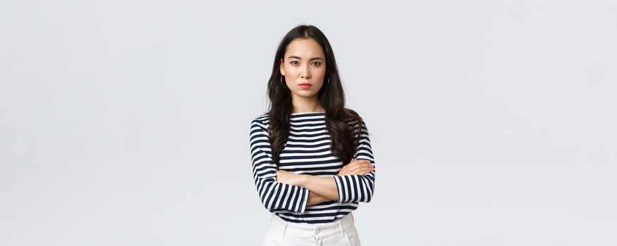 Lifestyle, people emotions and casual concept. Angry disappointed woman cant forgive betrayal, cross hands over chest and looking dismay and dislike camera, standing upset.