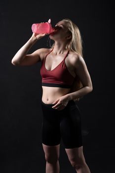 Shaker her pink a spotrsman in girl holds hand in black background shaker pink fitness caucasian, for health fit for healthy from active dumbbell, strong people. Care ABS beauty, happy