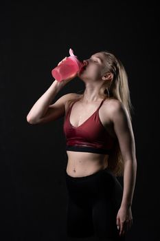 In holds shaker fitness sex hand pink a her girl in black background shaker pink black workout, from gym lifestyle for healthy for trainer isolated, sexy people. Sweat model beauty