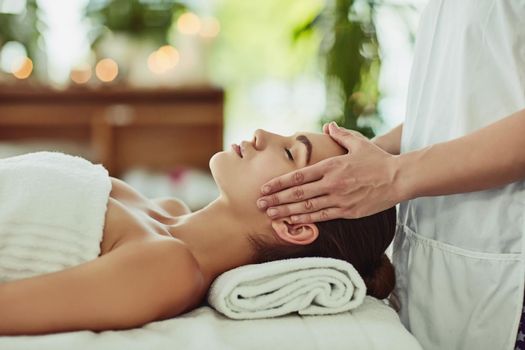 Shot of an attractive young woman getting massaged at a beauty spa.
