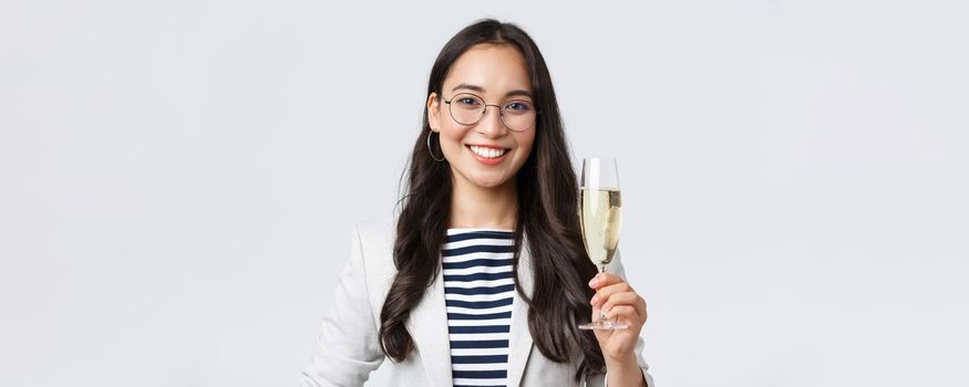 Business, finance and employment, female successful entrepreneurs concept. Happy asian businesswoman celebrating signing of contract, having office party, drinking champagne.