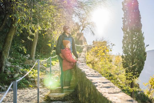 Dad and son travelers in Montenegro in Kotor Old Town Ladder of Kotor Fortress Hiking Trail. Aerial drone view.