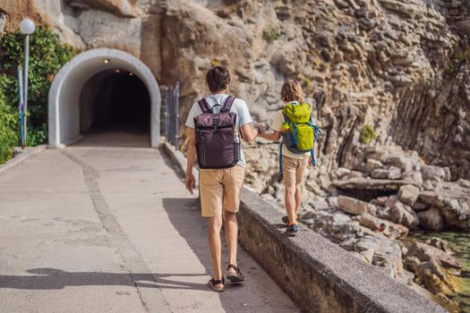 Dad and son tourists walks along the coast of Budva in Montenegro.