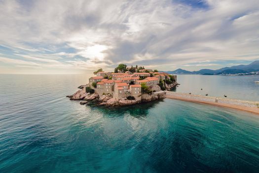 Aerophotography. View from flying drone. Panoramic view of Sveti Stefan island in Budva in a beautiful summer day, Montenegro. Top View. Beautiful destinations.