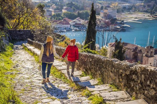 Mom and son travelers in Montenegro in Kotor Old Town Ladder of Kotor Fortress Hiking Trail. Aerial drone view.