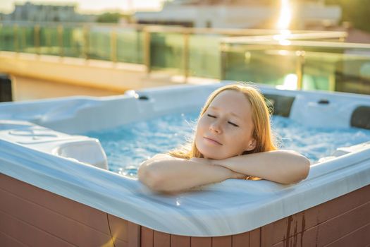 Portrait of young carefree happy smiling woman relaxing at hot tub during enjoying happy traveling moment vacation life against the background of green big mountains.