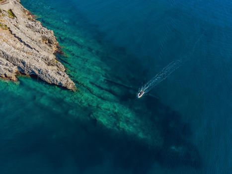 Picturesque sea Adriatic coast of Montenegro. Turquoise Mediteran sea and rocky shore with evergreen coniferous trees. Wonderful summer landscape. Drone.