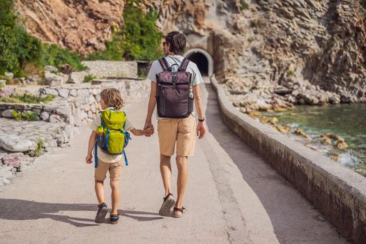 Dad and son tourists walks along the coast of Budva in Montenegro.