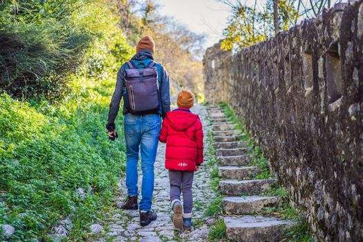 Dad and son travelers in Montenegro in Kotor Old Town Ladder of Kotor Fortress Hiking Trail. Aerial drone view.