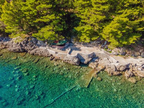 Picturesque sea Adriatic coast of Montenegro. Turquoise Mediteran sea and rocky shore with evergreen coniferous trees. Wonderful summer landscape. Drone.