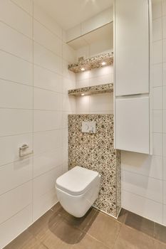 Design of a modern bathroom with a hinged toilet and an unusual back wall in a modern house