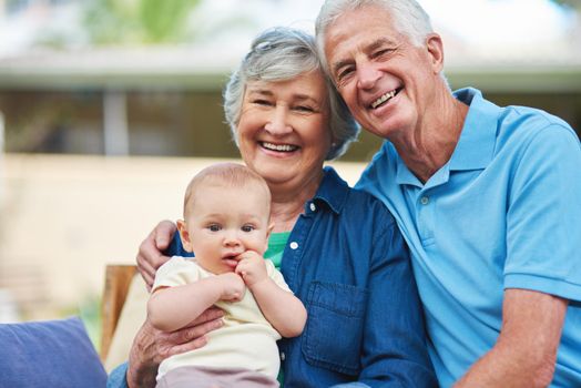 Cropped shot of a senior couple spending time with their grandson.