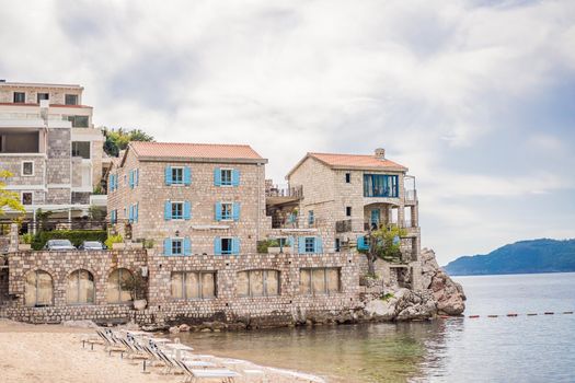 Picturesque summer view of Adriatic sea coast in Budva Riviera near Przno village. Cozy beach and buildings on the rock. Location: Przno village, Montenegro, Balkans, Europe.