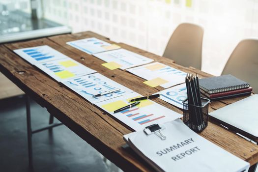 Brainstorming, consultation, data analysis, planning, marketing, accounting, economics, meeting budget papers placed on a wooden table