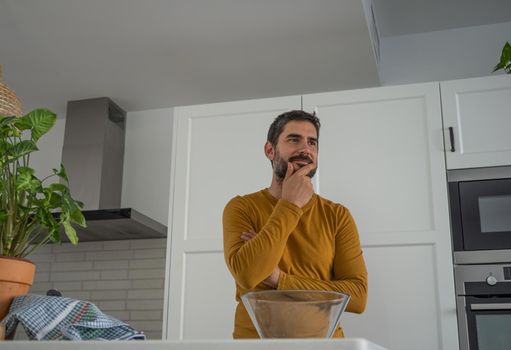 young bearded man making artisan bread in his home kitchen
