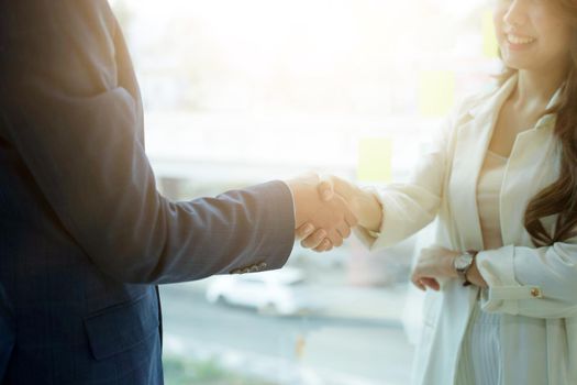 Business asian people shaking hands, finishing up meeting.