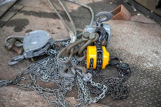 crane lift with steel chain and  hooks on the floor