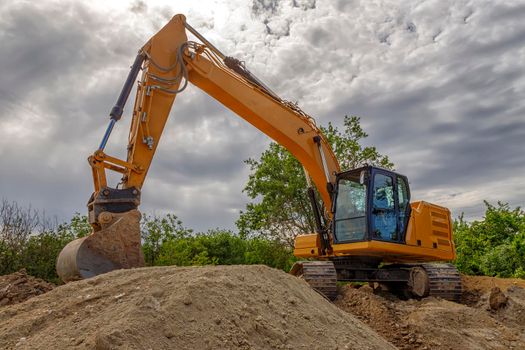 Break, big excavator with a shovel at the construction site. Horizontal view