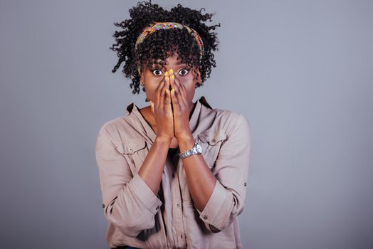 Oh my god gesture. Attractive afro american woman in casual clothes in the studio.