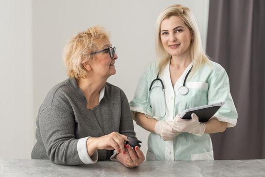 Doctor examining patient with fingertip pulse oximeter.