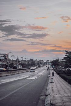 VERTICAL Real photo, sunset dark evening night pink sky background, nature beauty View wide open suburb city asphalt roadway paved highway stretch far distance summer time. Warm romantic tone Vintage