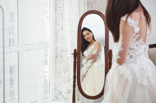 She's ready to say yes to the dress. The process of fitting the cloth in the studio of hand crafted clothes.