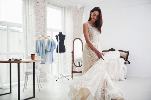 Wedding part is waiting. The process of fitting the dress in the studio of hand crafted clothes.