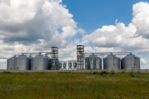 Landscape with modern agricultural Silo. Set of storage tanks cultivated agricultural crops processing plant. 