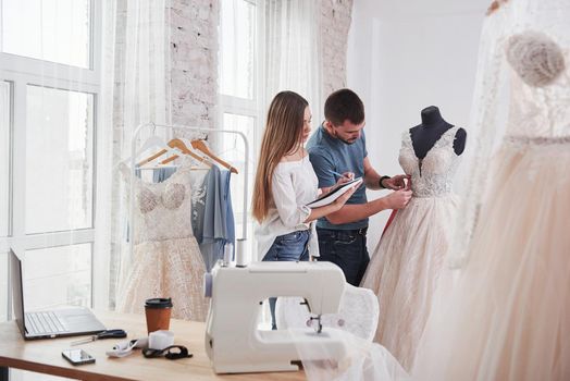 Notes in the textbook. The process of fitting the dress in the studio of hand crafted clothes.